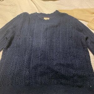 Navy cable knit sweater with ruffle collar.